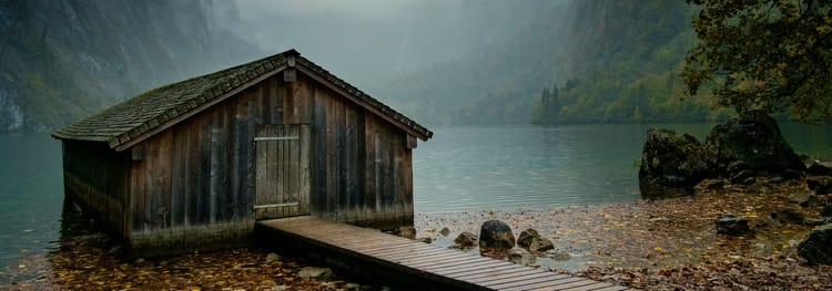 cozy remote cabin on the shore of a lake or fjord