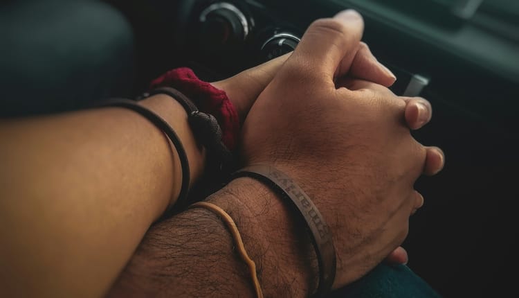 close-up on two people holding hands