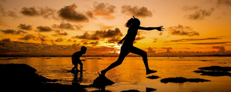 people running near the seashore shore at sunset