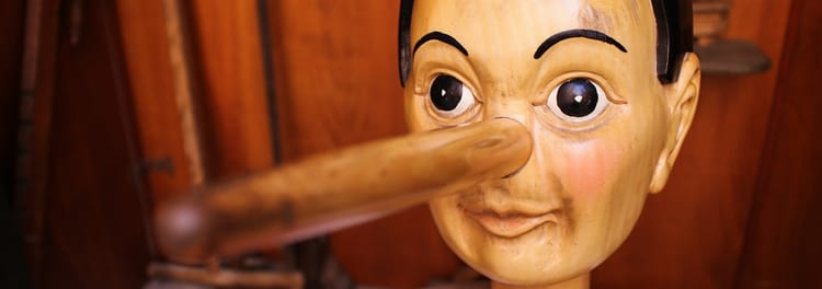 creepy looking wooden pinocchio doll with long nose