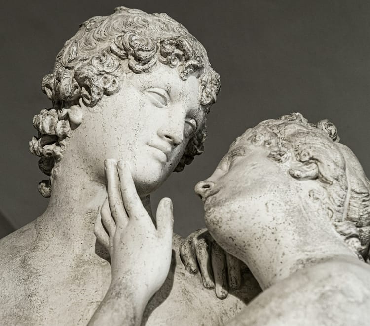 statue of two lovers nearly kissing