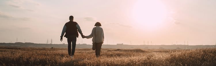 couple walking in a field