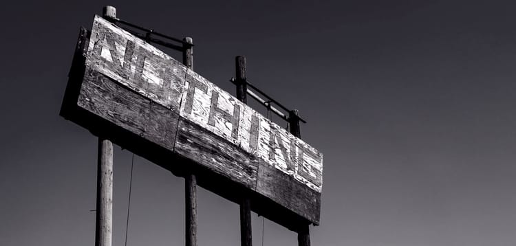 abandoned roadside advertising sign worn by time saying nothing