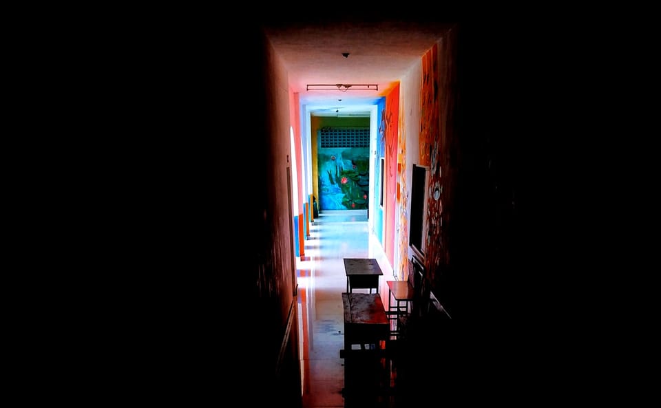 light and color at the end of a long dark hallway