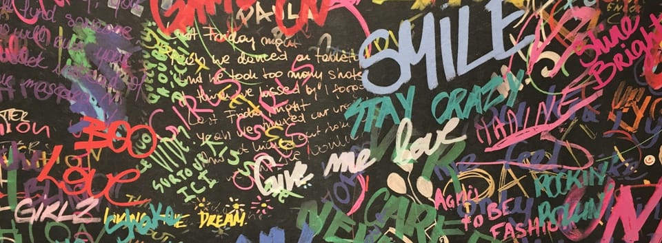 many colorful words scrawled on a wall