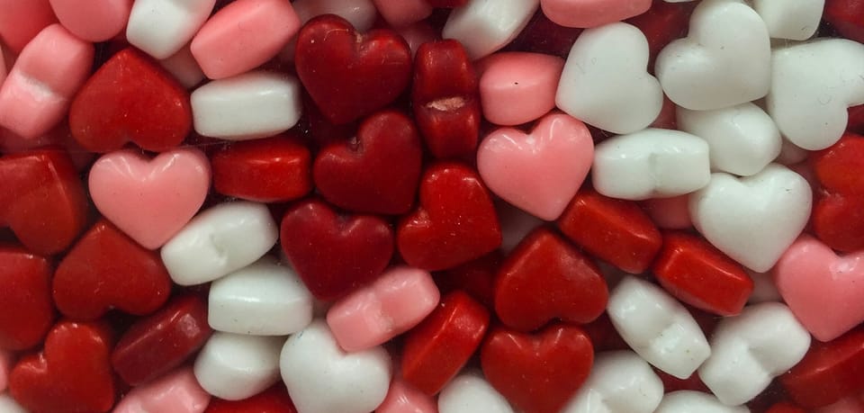 close-up shot of candy hearts in a glass container