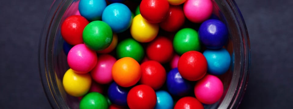 colorful gum balls in a glass dish